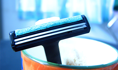 Is it permissible to use an electric trimmer instead of a razor to remove pubic hair?